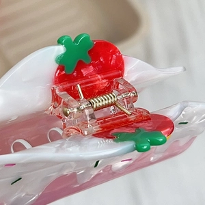 Pink translucent strawberry hair claw clip with red fruit charms and golden metal spring