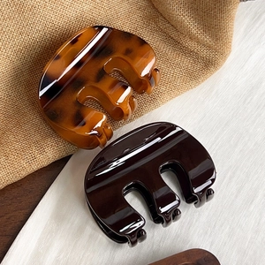 Minimalist medium M-shaped pumpkin hair claw clips in amber and dark coffee resin finish