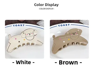 Detail of white and brown puppy hair claws with colorful star patterns on a ceramic plate