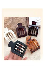 Detail view of various matte hair claw clips including tortoiseshell and solid colors