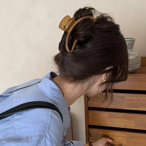 Large wood grain texture hair claw clip with cutout design for elegant women's low bun styling