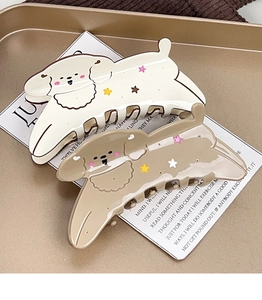 Detail of cute cream and brown puppy hair claws with star patterns on vintage paper