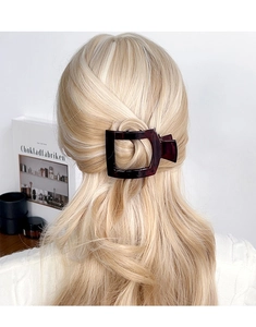 Brown tortoiseshell square hair clip styled on hair for a minimalist aesthetic