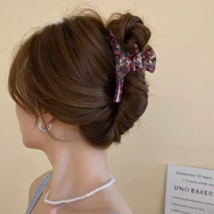 Large vintage tortoiseshell claw clip for thick hair shown on elegant updo hairstyle