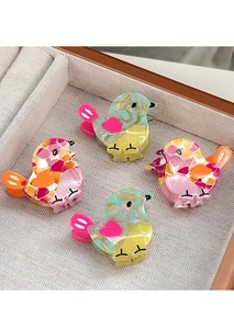 Set of four colorful bird-shaped acetate hair claws with marble textures in a gift box