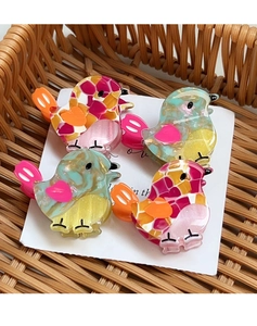 Set of four colorful bird-shaped hair clips with acetate marble texture on card