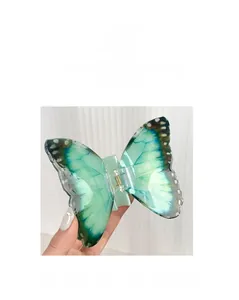 Vue détaillée d'une pince à cheveux papillon dégradé vert avec ailes et ressort
