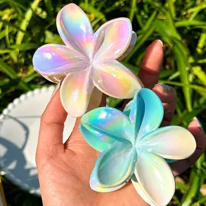 Detailed macro view of iridescent flower hair claws with a pearlescent gradient finish
