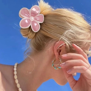 Pinza per capelli a fiore di frangipane rosa per acconciature estive su cielo blu