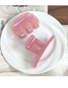 Detail of translucent pink jelly hair claw clips in square and semi-circle geometric designs