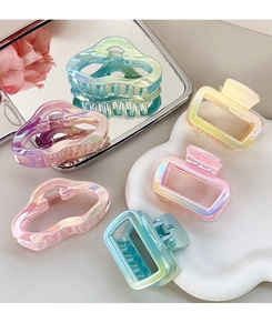 Iridescent gradient hair claws set with wave and rectangular shapes on a tray
