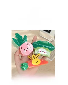 Close-up of vibrant vegetable-shaped acetate hair claws including broccoli and carrot
