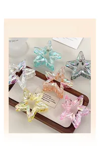 Close-up of laser-textured star hair claw clips in colorful iridescent acrylic set
