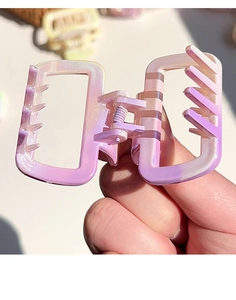 Detail of square gradient hair claw clip with pearlescent finish and strong metal spring