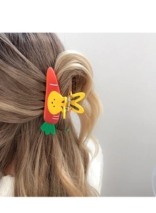 Detailed back view of a carrot and rabbit hair claw clip securing a woman's long hair