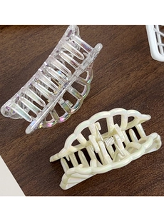 Detail of colorful hollow shark hair clips with iridescent finish and metal spring