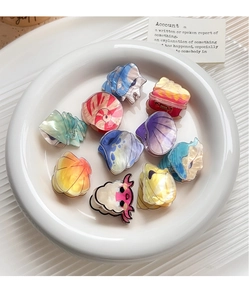 Set of 10 ocean-themed acrylic hair clips with iridescent pearlescent finish in a white dish