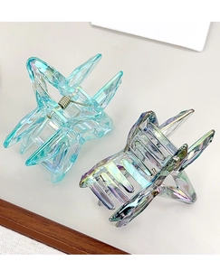 Close-up of crystal laser star hair clips with iridescent finish and metal springs