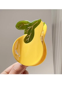 Detail view of a bright yellow pear-shaped hair claw with green leaves and gold veins