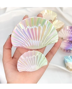 Detail of shell-shaped hair claw clips with gradient pearl finish in two sizes