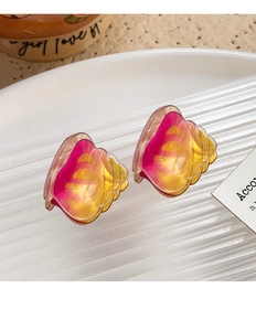Detailed macro shot of shell-shaped resin hair clips with pink and yellow gradient colors