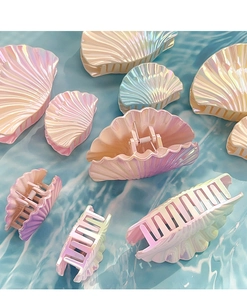 Detail view of colorful shell hair claws with pearl luster and metal spring in various sizes