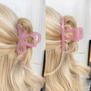 Elegant jelly pink hair claw clips in matte resin shown on long blonde hair