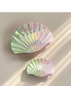 Detailed view of iridescent shell-shaped jewelry trays with elegant ribbed light shadows