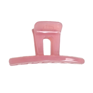 Pink translucent rectangular claw clip for hair with glossy minimalist finish