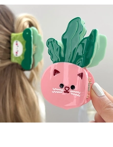 Detailed close-up of pink and green acetate cat vegetable hair claws with glossy finish