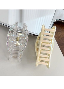 Detail of colorful hollow shark hair clips with pearl finish and golden spring