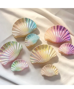 Macro detail of holographic shell hair claws with pearlescent finish in various sizes