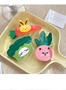 Detailed set of cute cartoon vegetable hair claws including carrot and broccoli designs
