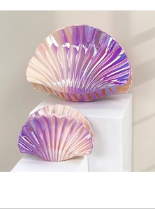 Detail of gradient purple shell hair claws with pearlescent finish and seashell texture