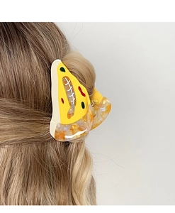 Detailed view of creative pizza slice hair claw clip secured on long wavy hair