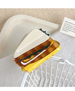 Detailed view of creative sandwich cake hair claw clip in layered acetate on white basket