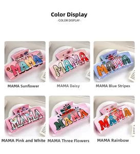 Macro view of assorted acrylic hair claw clips with floral and rainbow MAMA designs