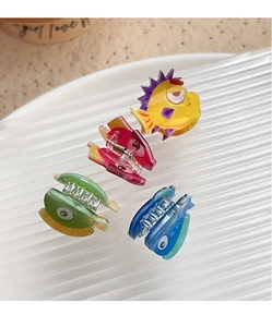Vue de dessus de quatre pinces à cheveux en acrylique en forme de poisson coloré