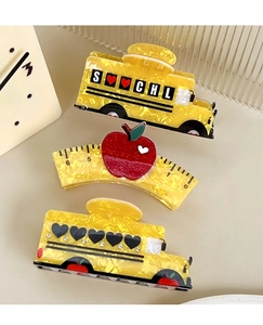 Detailed set of school-themed hair claws featuring yellow bus, ruler, and red apple motifs