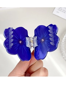 Detail of blue sunflower acrylic hair claw clip with strong transparent plastic spring