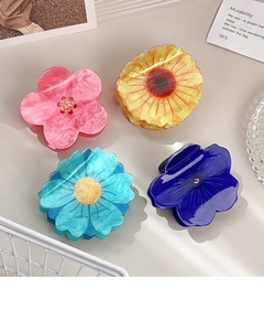 Set of four acrylic floral hair claws in pink, orange, and blue with marble texture finish