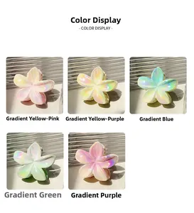 Detail view of tropical plumeria hair claws showing iridescent pearlescent gradient finishes