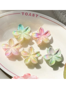 Detailed set of five iridescent frangipani flower hair clips in pastel gradient colors