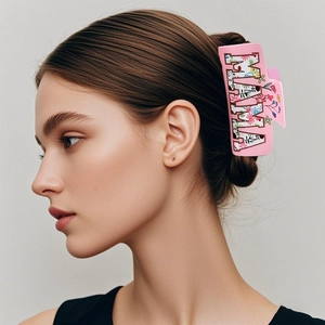 Pink large square hair claw clip with MAMA floral lettering worn by a female model