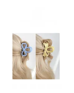 Détail de pinces à cheveux nśud bleu clair et jaune avec découpes en forme de cśur