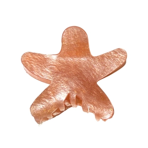 Sparkling pink starfish hair claw clip made of acrylic with glitter for summer hairstyles