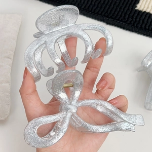 Bright silver glitter hair claw clips in arched and bow shapes for elegant updos