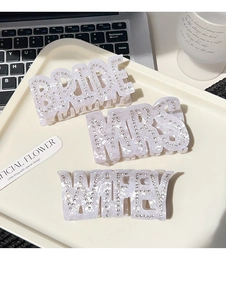 Détail des pinces à cheveux BRIDE MRS et WIFEY en acétate avec strass scintillants
