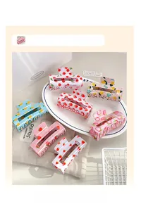 Collection of seven rectangular resin hair claw clips featuring colorful fruit patterns