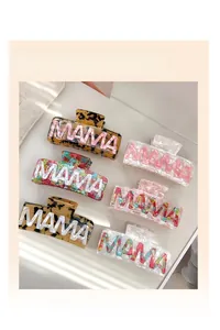 Detail showing set of six colorful rectangular hair claw clips with MAMA lettering